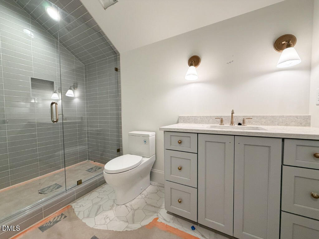 1513 Rock Dove Way Raleigh, NC 27614 - Photo 30 of 38 a bathroom with a granite countertop toilet sink and mirror