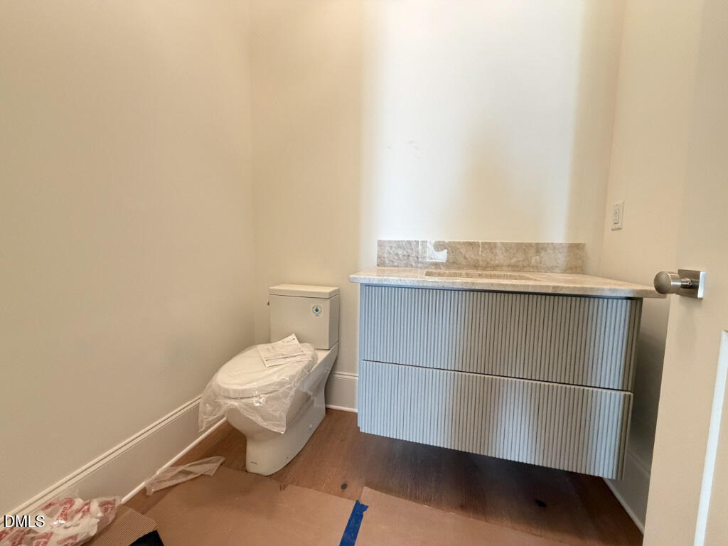 1513 Rock Dove Way Raleigh, NC 27614 - Photo 33 of 38 a bathroom with a sink a toilet and vanity