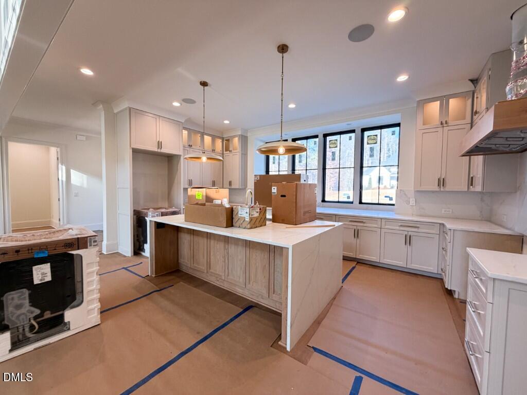 1513 Rock Dove Way Raleigh, NC 27614 - Photo 4 of 38 a kitchen with stainless steel appliances kitchen island granite countertop a stove a sink and a refrigerator