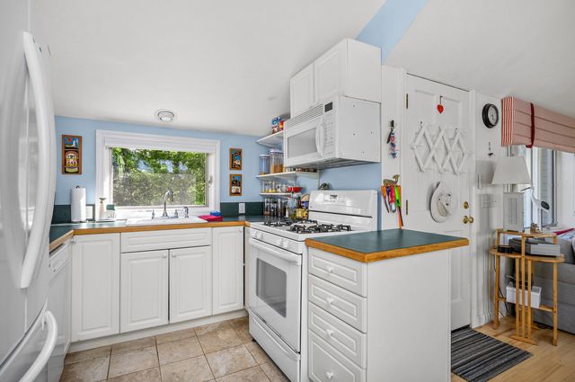 a kitchen with a sink a stove and cabinets