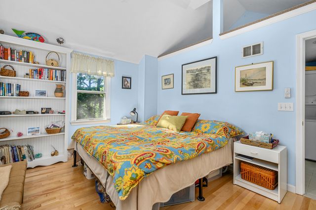 a bedroom with bed and a book shelf