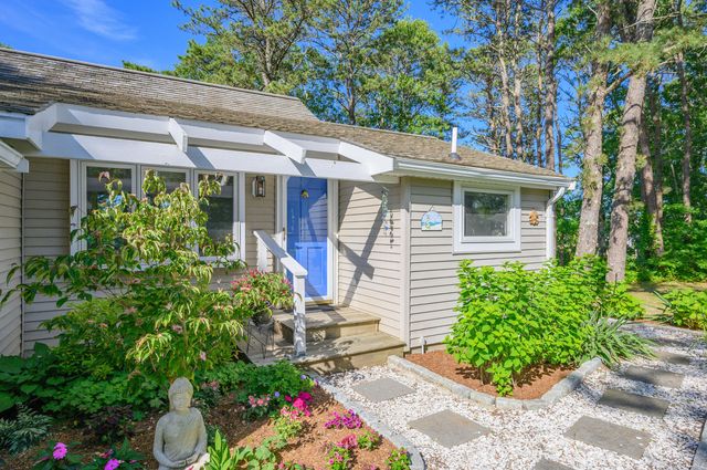 a front view of a house with a garden