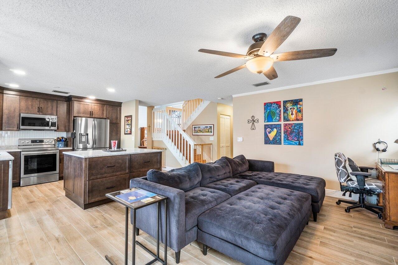 7250 Davit Circle Lake Worth, FL 33467 - Photo 15 of 35 a spacious bedroom with a bed and a chandelier