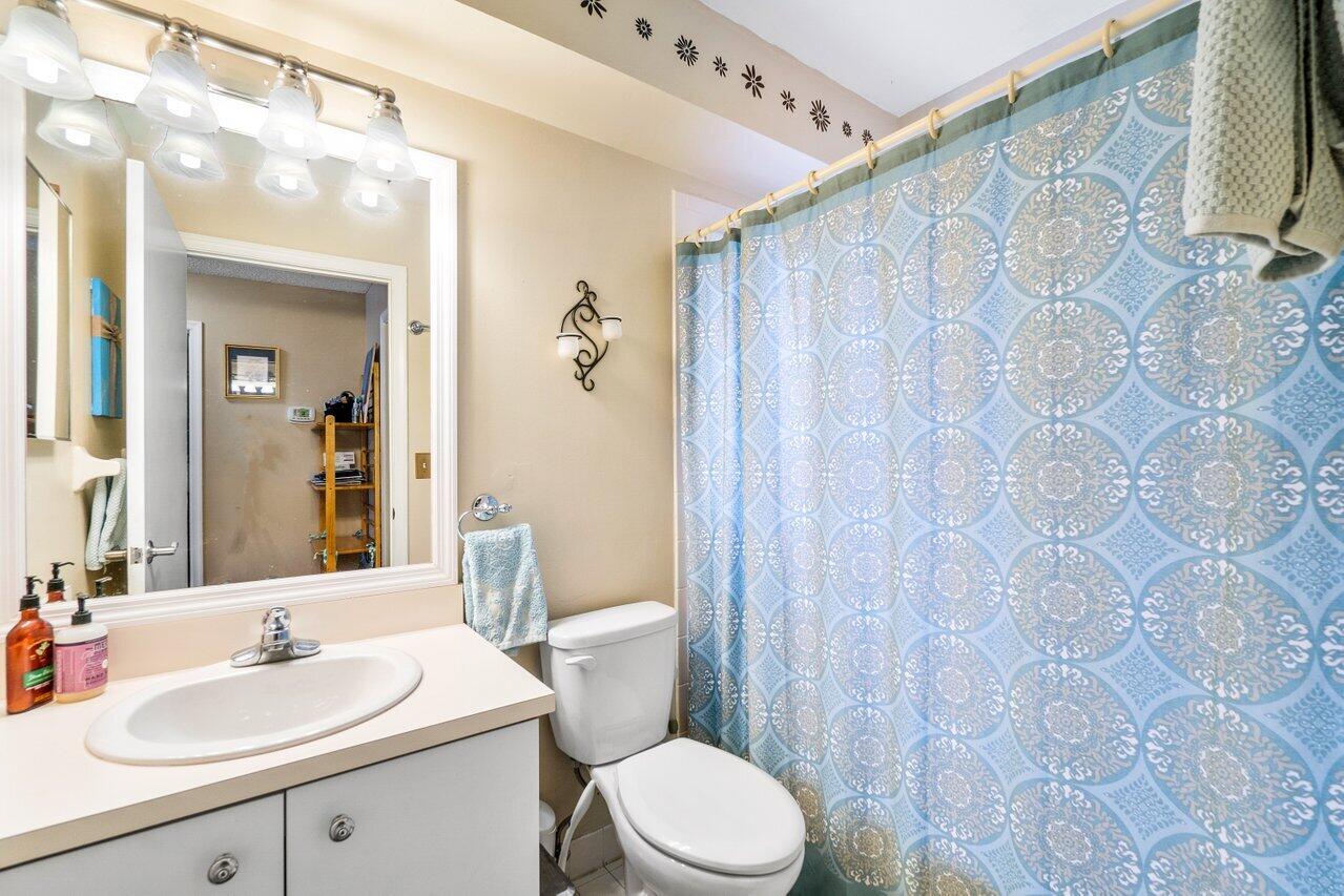 7250 Davit Circle Lake Worth, FL 33467 - Photo 16 of 35 a bathroom with a sink mirror vanity and toilet