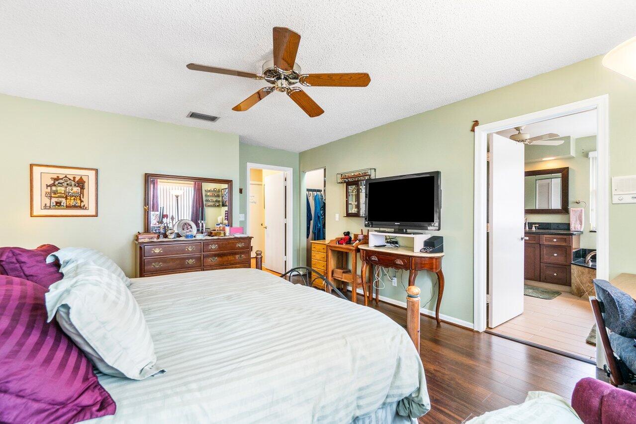 7250 Davit Circle Lake Worth, FL 33467 - Photo 19 of 35 a bedroom with a bed and a flat screen tv