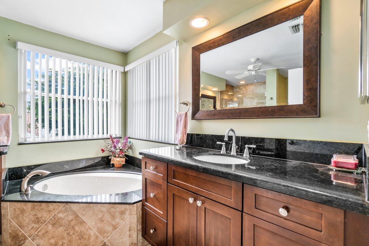 7250 Davit Circle Lake Worth, FL 33467 - Photo 20 of 35 a bathroom with a granite countertop sink and a large mirror