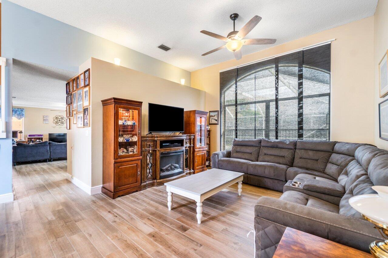 7250 Davit Circle Lake Worth, FL 33467 - Photo 7 of 35 a living room with furniture a large window and a flat screen tv
