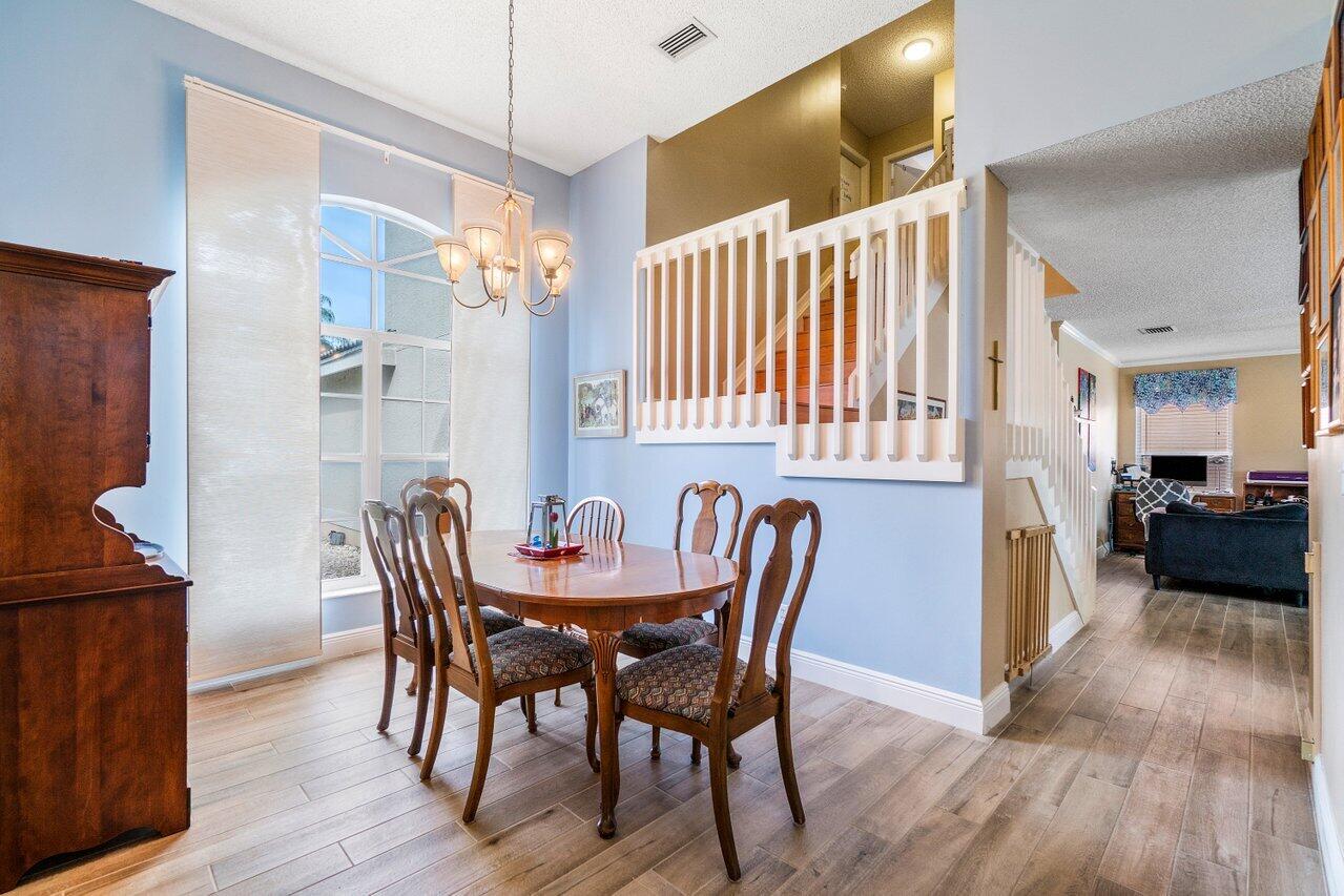 7250 Davit Circle Lake Worth, FL 33467 - Photo 8 of 35 a view of a dining room with furniture and wooden floor