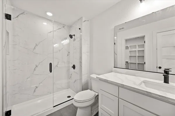 a bathroom with a sink toilet and shower
