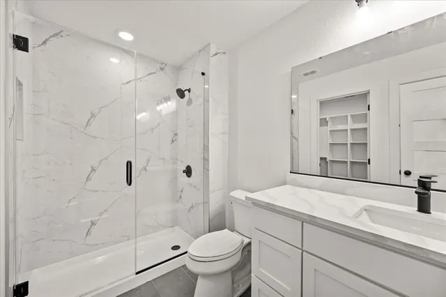 a bathroom with a sink toilet and shower