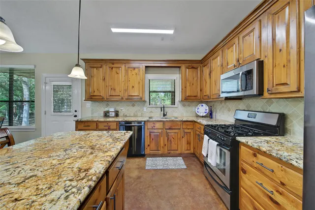 a view of a dining room with furniture and a chandelier