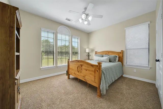a view of a hallway with workspace and a window