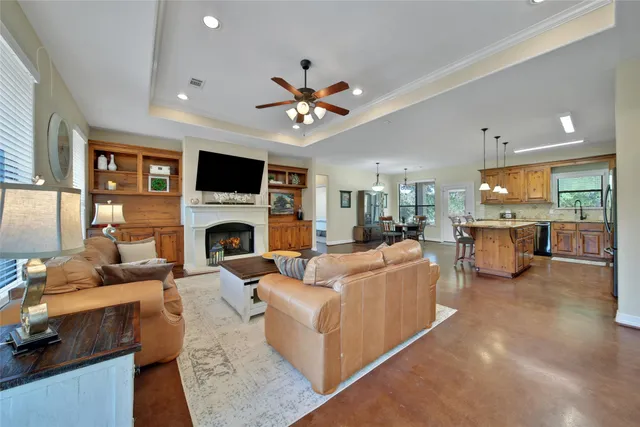 a living room with furniture a fireplace and a flat screen tv