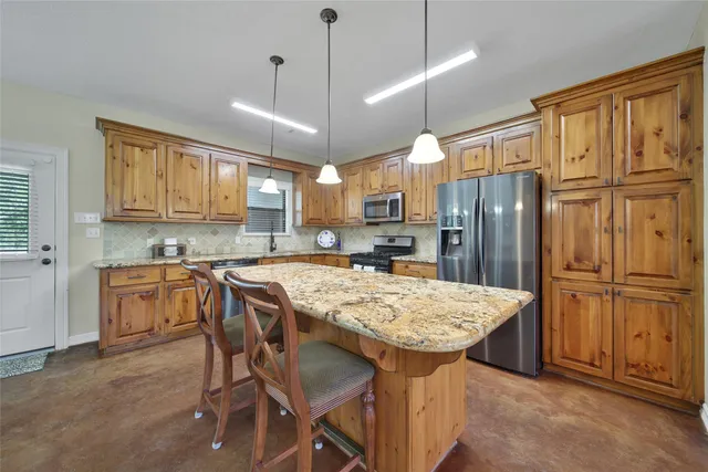 a kitchen with stainless steel appliances granite countertop a stove sink microwave and cabinets
