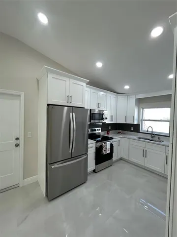 a kitchen with a refrigerator and a sink