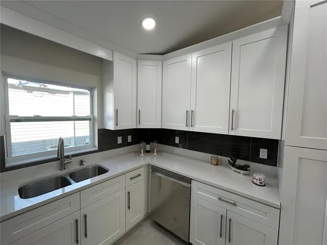 a kitchen with a sink cabinets and window