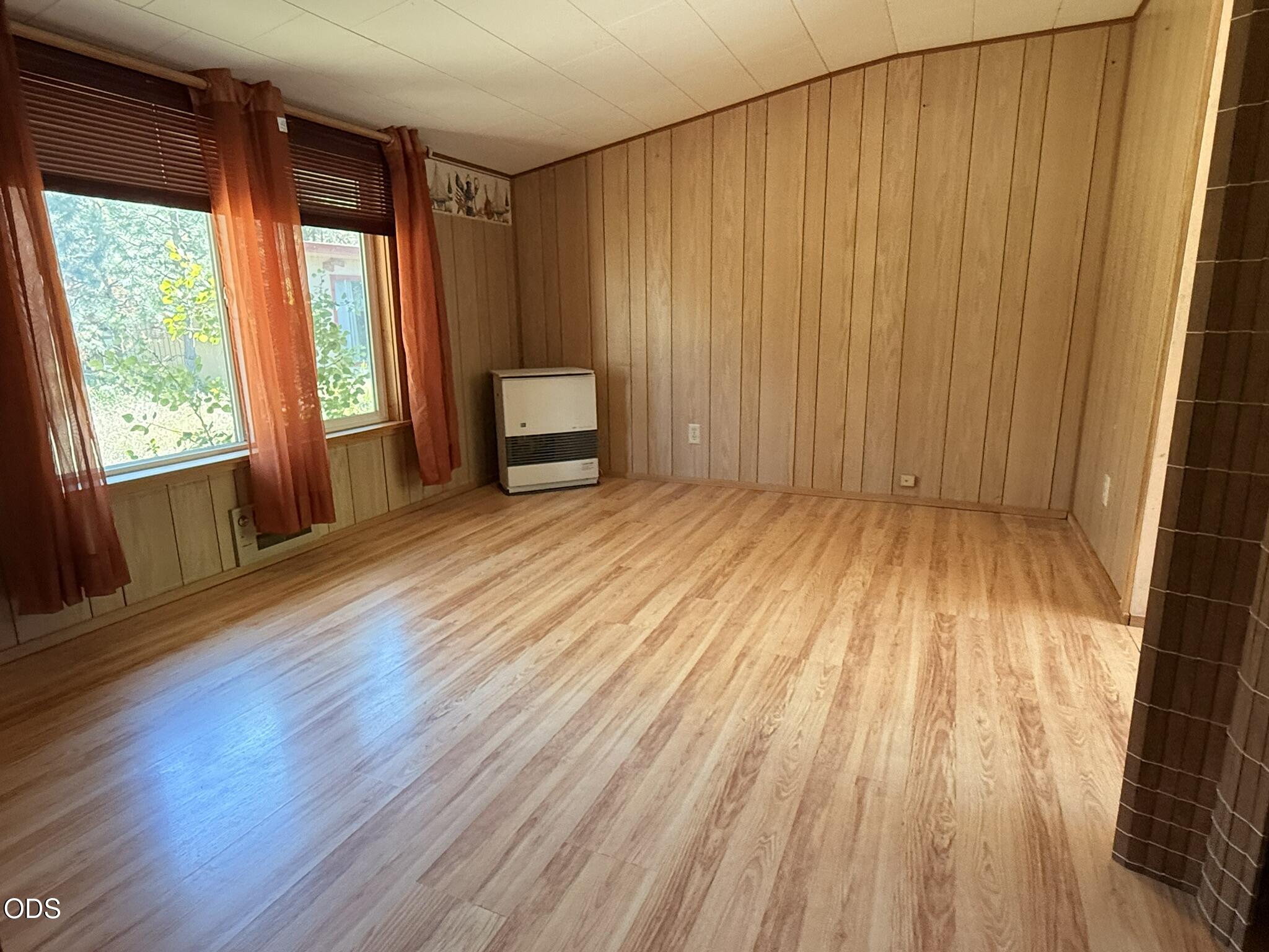 16025 Strawn Road La Pine, OR 97739 - Photo 50 of 95 a view of an empty room with wooden floor and a window