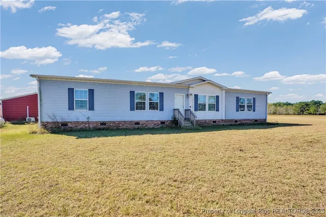 a front view of house with yard and swimming pool