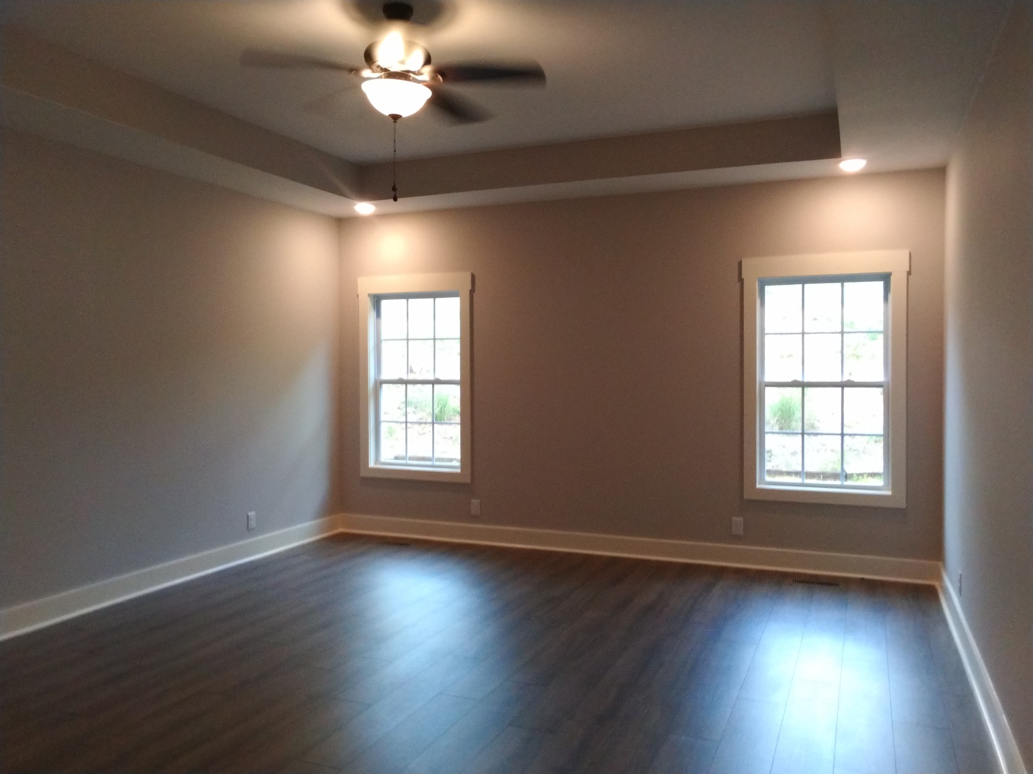 2006 McMahan Hollow Road Pleasant View, TN 37146 - Photo 10 of 20 an empty room with wooden floor chandelier fan and windows