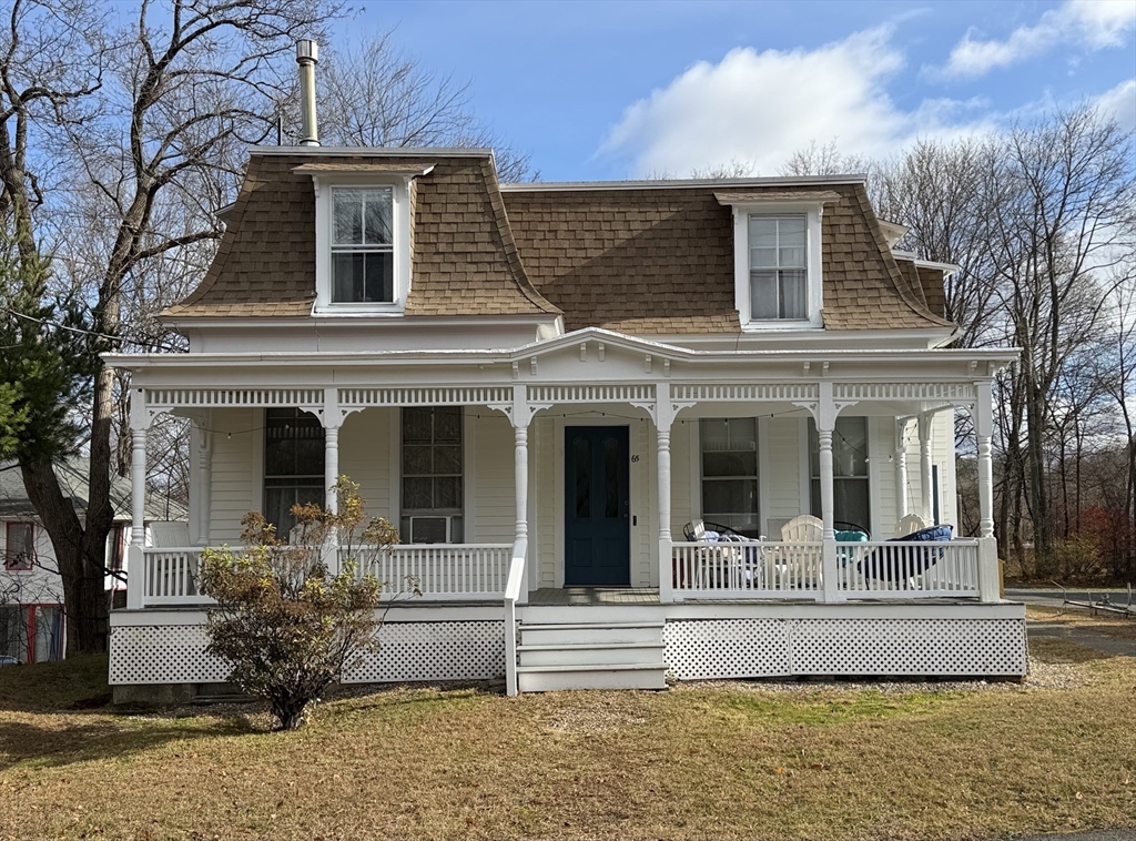 a view of a house with a fountain in a patio