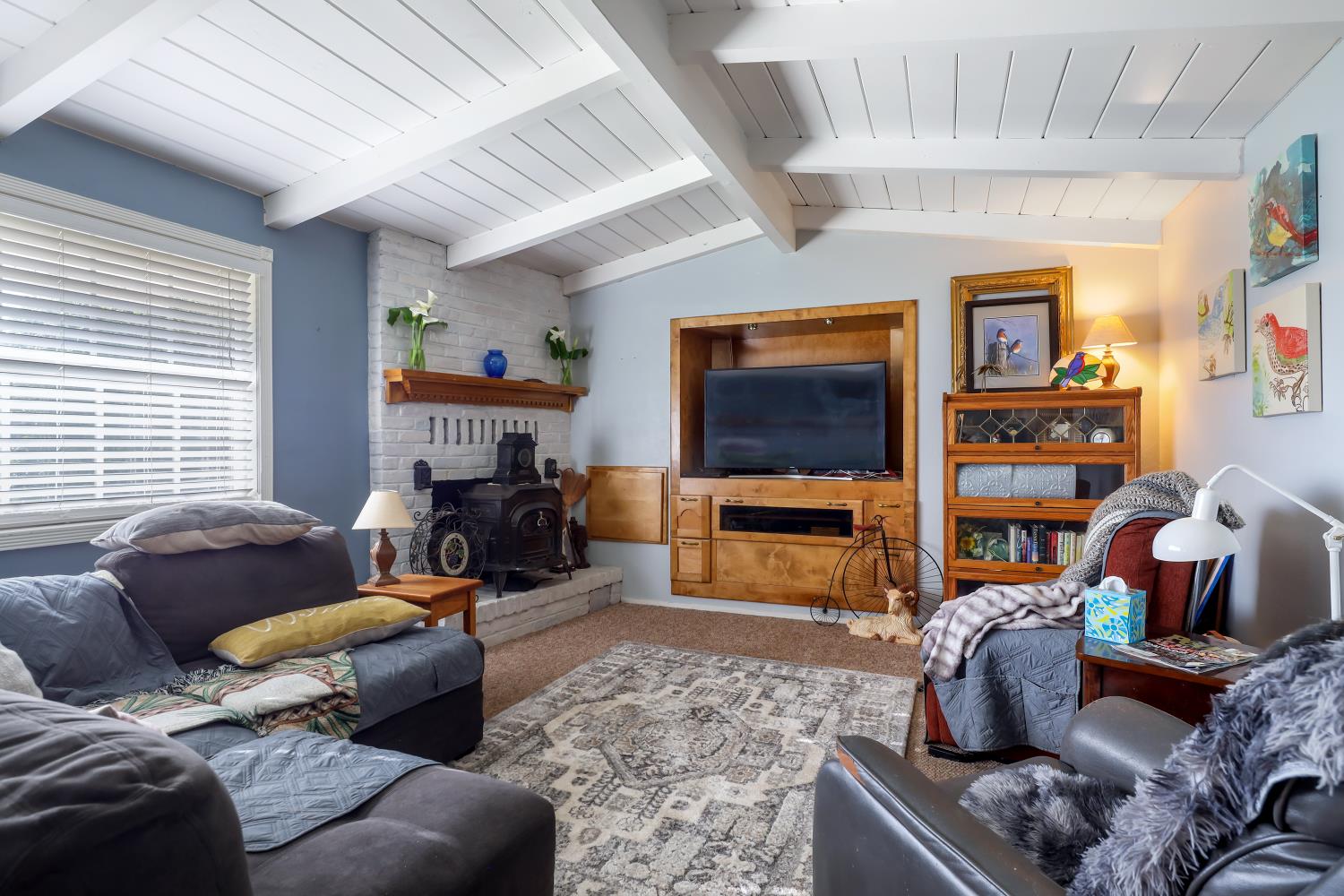 23404 Bruella Road Acampo, CA 95220 - Photo 29 of 69 a living room with furniture a flat screen tv and a fireplace
