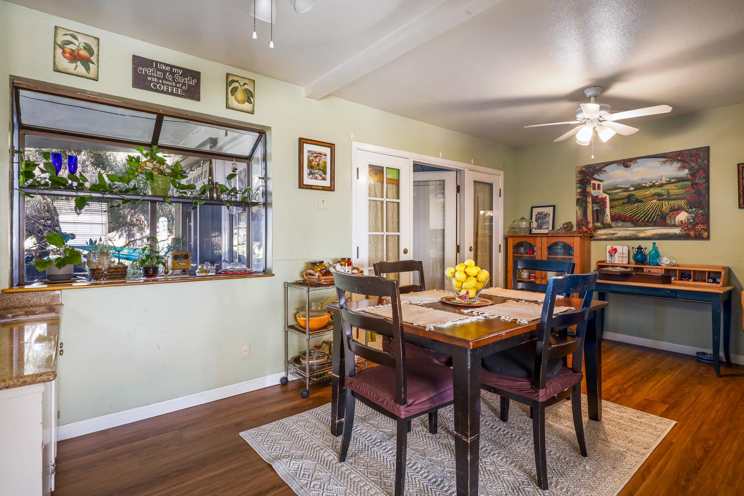 23404 Bruella Road Acampo, CA 95220 - Photo 32 of 69 a view of a dining room with furniture window and wooden floor