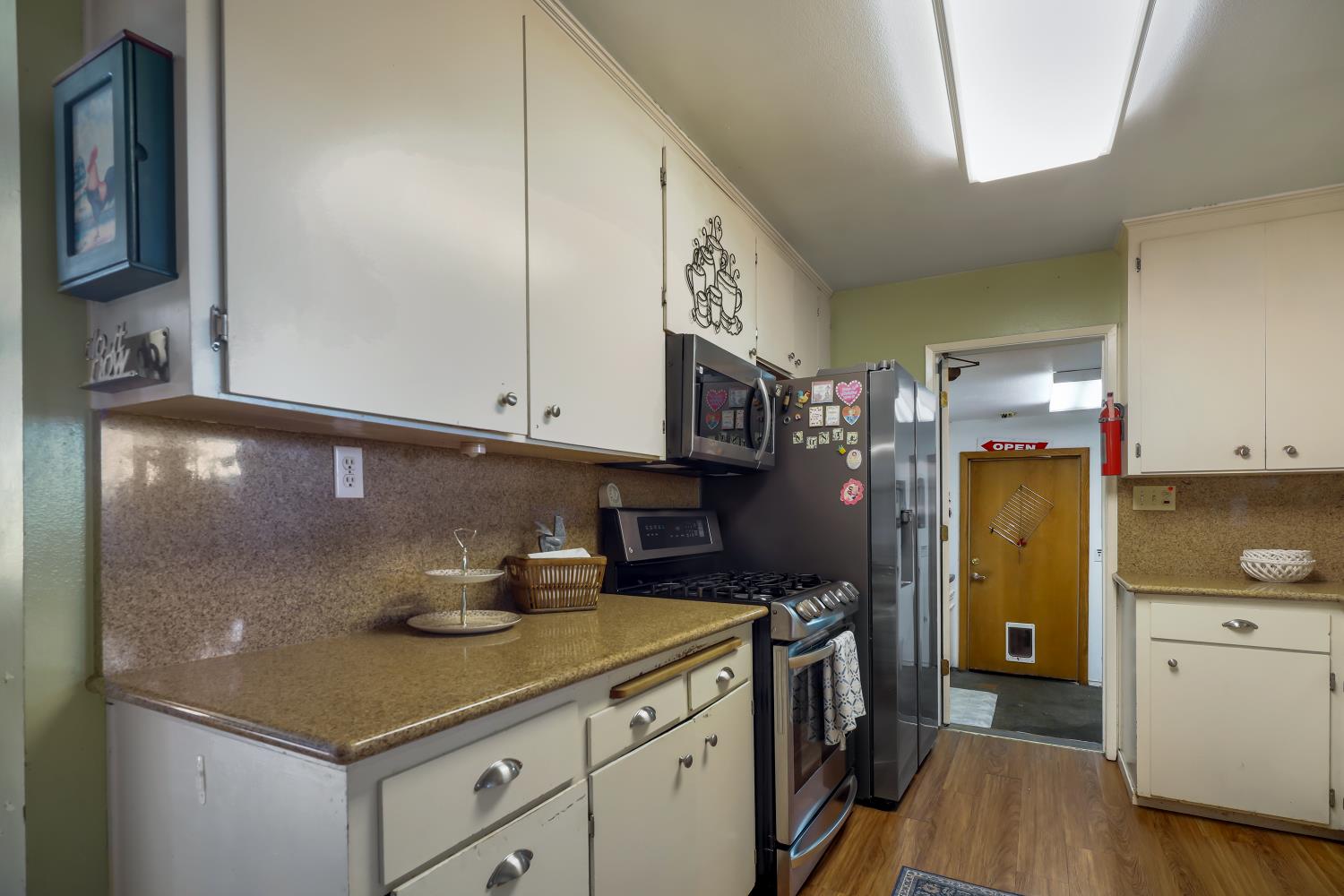 23404 Bruella Road Acampo, CA 95220 - Photo 38 of 69 a kitchen with a sink and wooden cabinets
