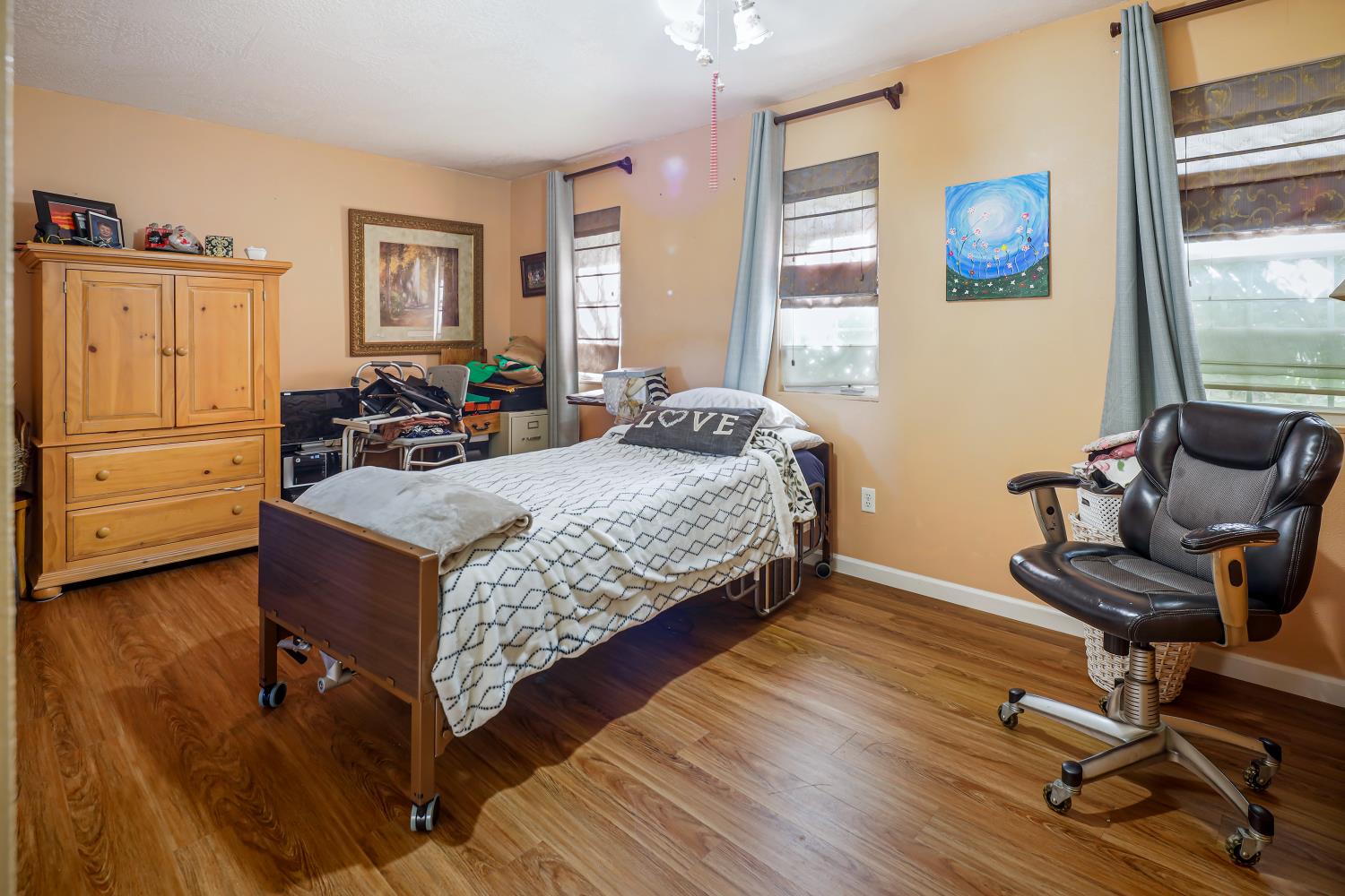 23404 Bruella Road Acampo, CA 95220 - Photo 42 of 69 a bedroom with a bed and wooden floor