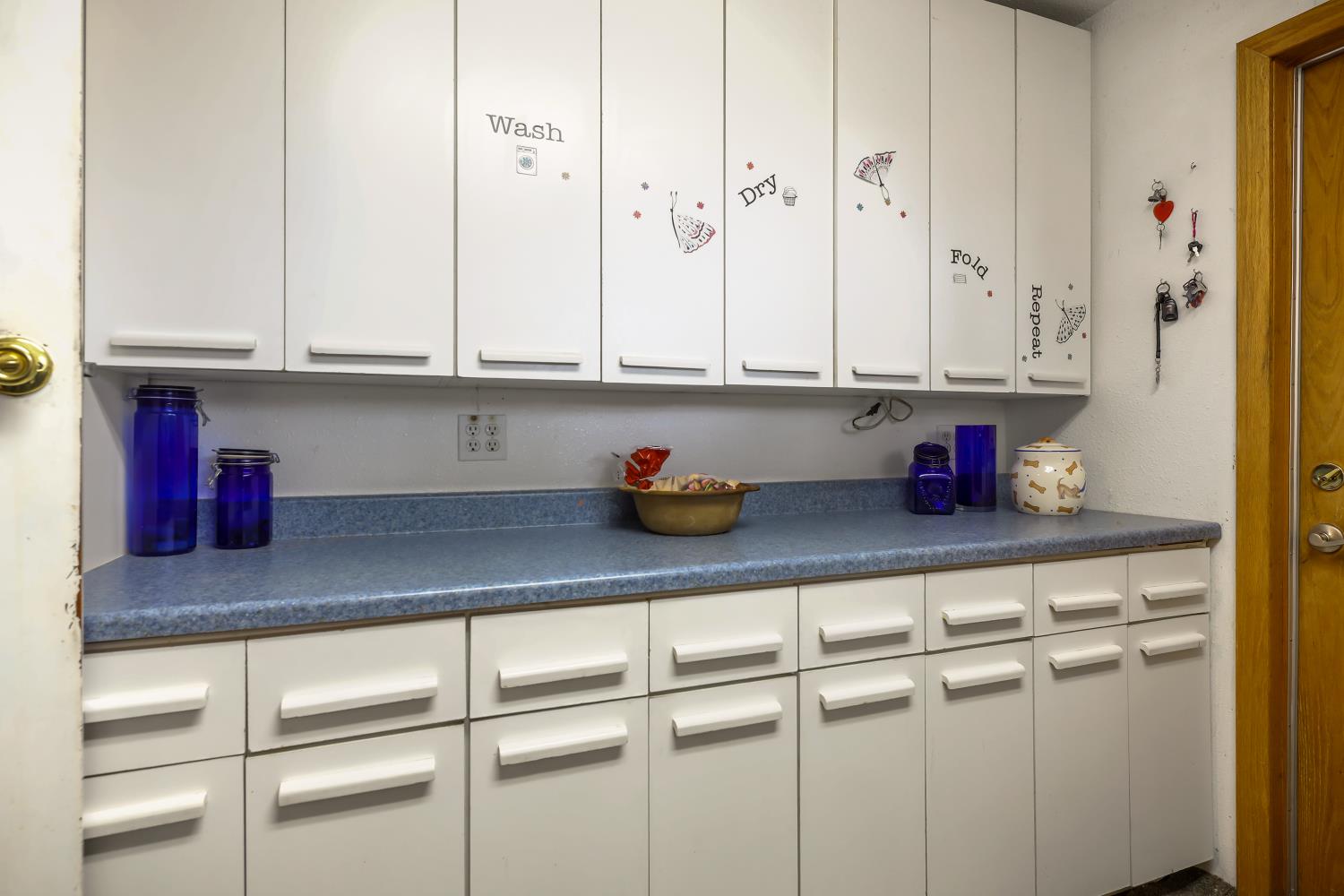 23404 Bruella Road Acampo, CA 95220 - Photo 49 of 69 a kitchen with white cabinets and a sink