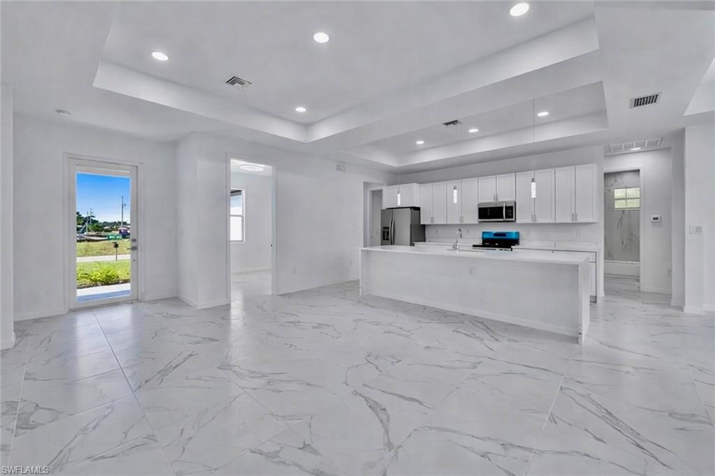 4113 19th Street Southwest Lehigh Acres, FL 33976 - Photo 2 of 3 a view of kitchen with stainless steel appliances refrigerator sink and cabinets