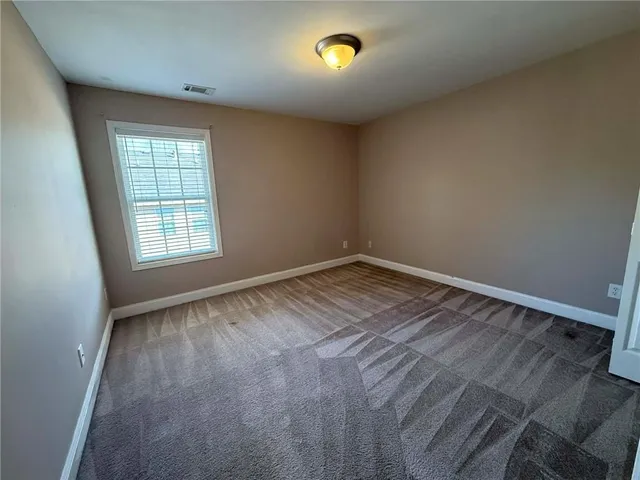 a view of an empty room with empty shelves