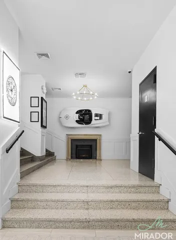 a view of a livingroom with an empty space and a fireplace