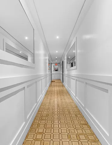 a very nice looking hallway with a kitchen