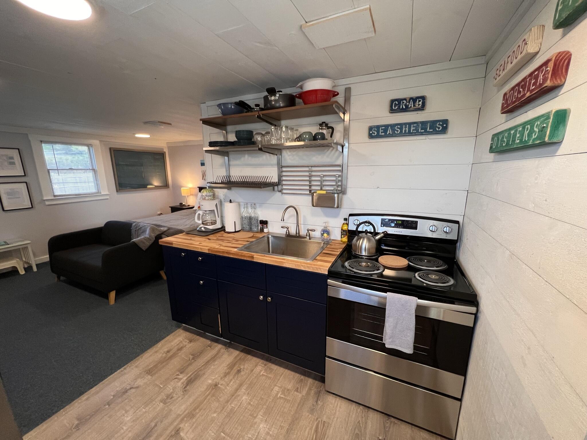 168 Shore Road, Unit 3 Truro, MA 02666 - Photo 11 of 14 a kitchen with a stove and a cabinet