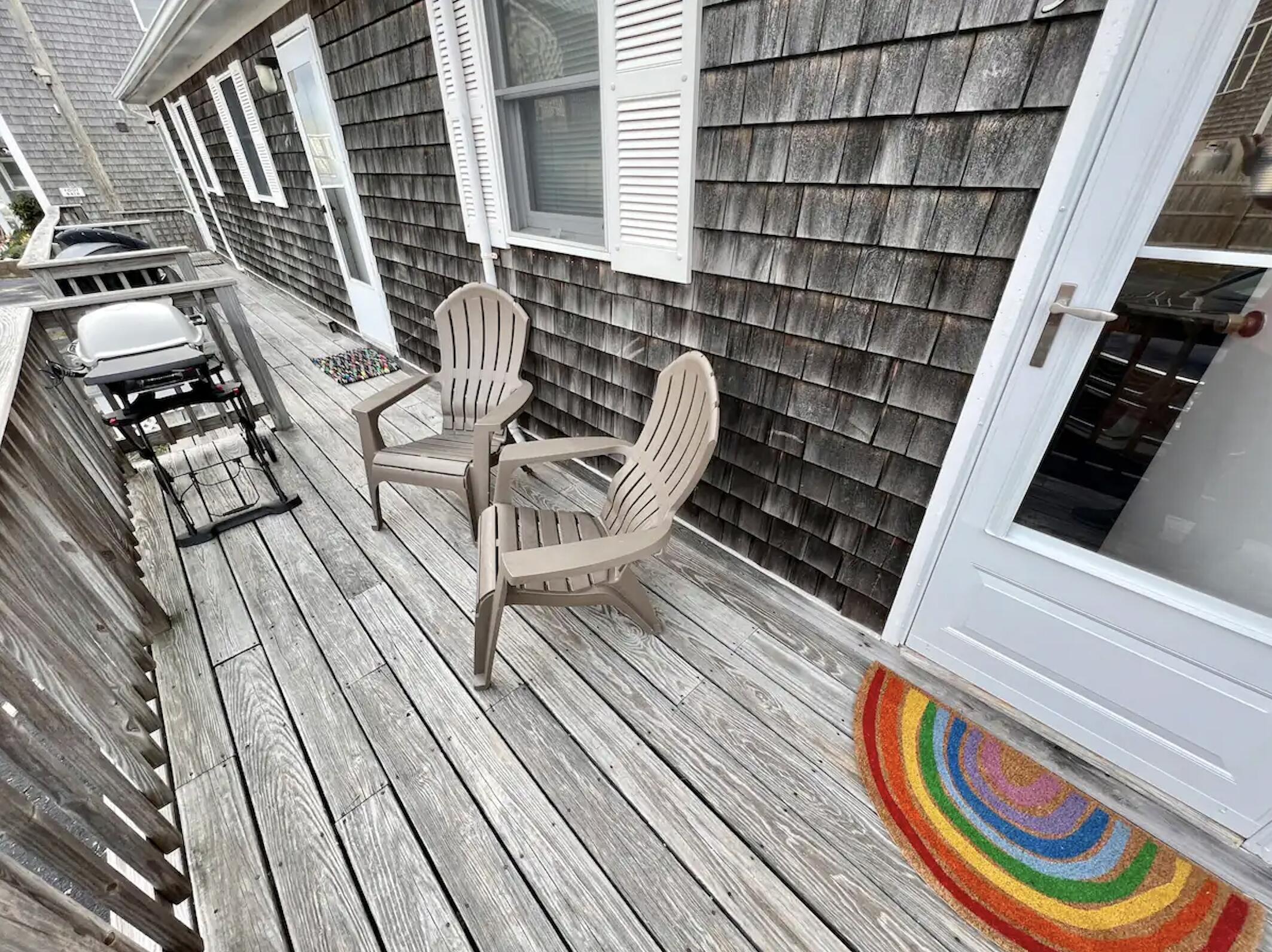 168 Shore Road, Unit 3 Truro, MA 02666 - Photo 2 of 14 a balcony with wooden floor and furniture