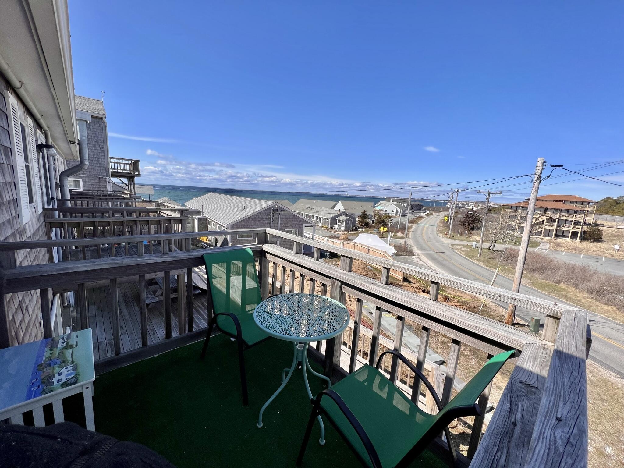 168 Shore Road, Unit 3 Truro, MA 02666 - Photo 3 of 14 a view of a balcony with chairs