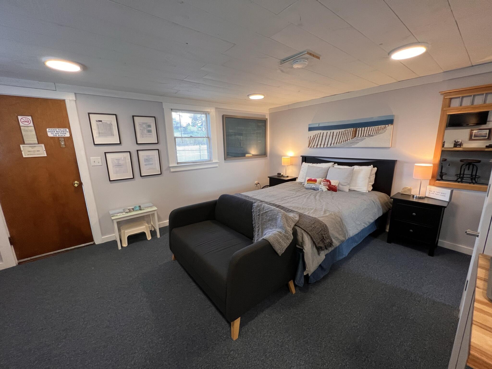 168 Shore Road, Unit 3 Truro, MA 02666 - Photo 7 of 14 a bedroom with a bed couch and a window