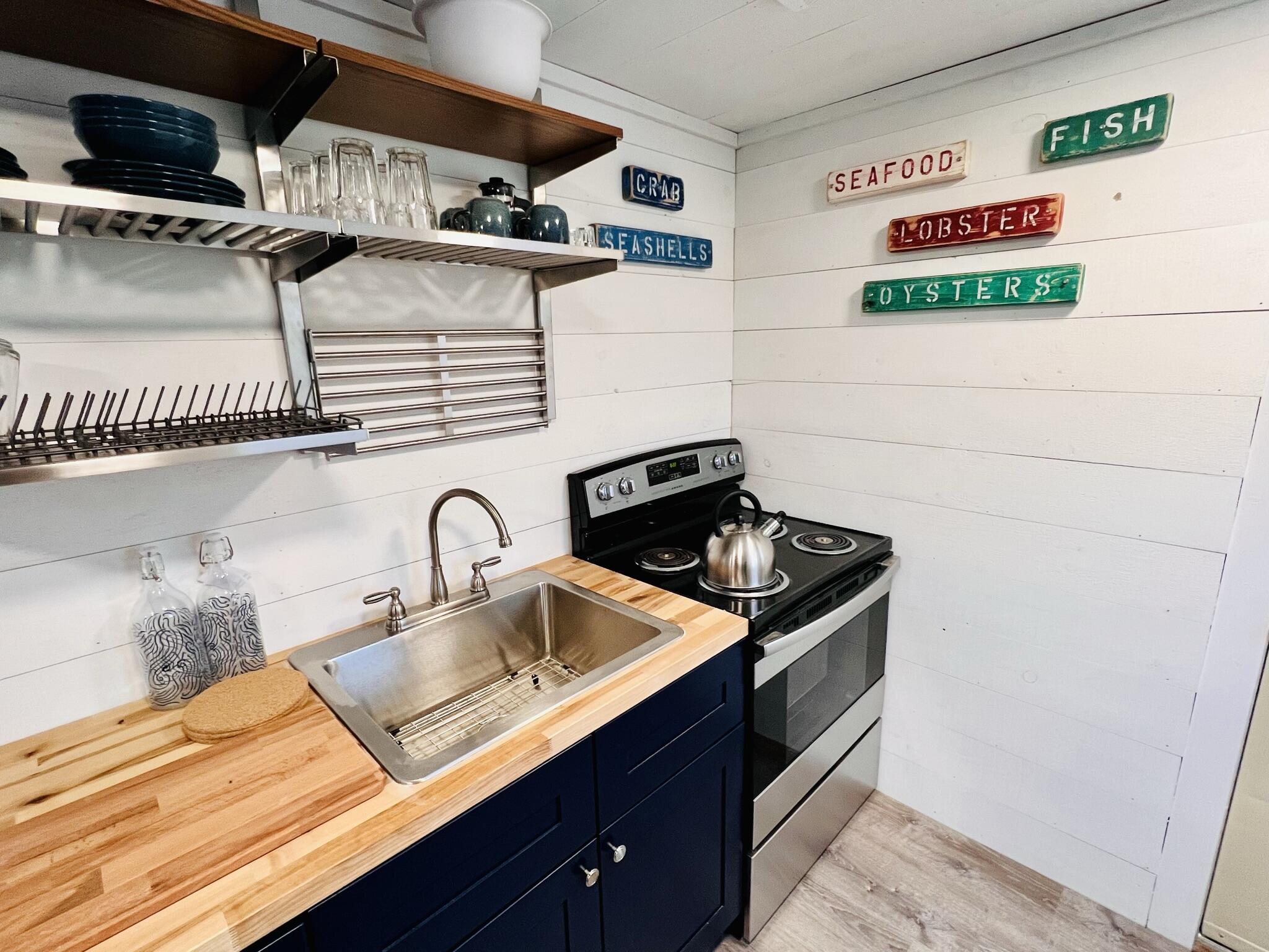 168 Shore Road, Unit 3 Truro, MA 02666 - Photo 10 of 14 a kitchen with stainless steel appliances granite countertop a sink and a stove