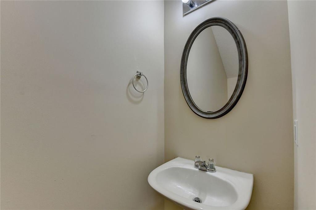 310 Azalea Circle Cumming, GA 30040 - Photo 15 of 38 a bathroom with a sink and a mirror