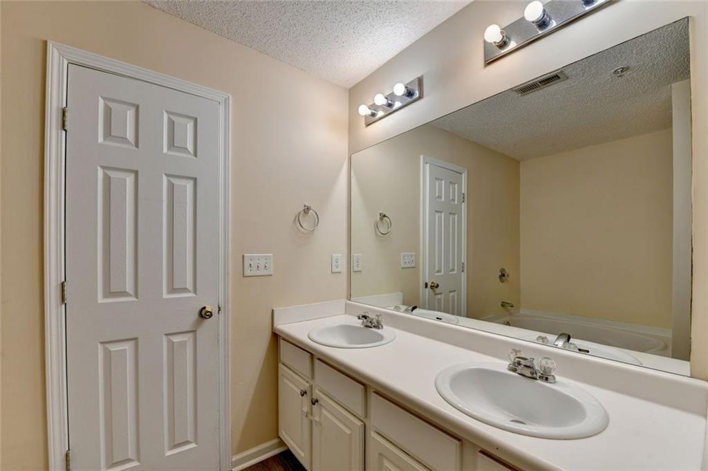 310 Azalea Circle Cumming, GA 30040 - Photo 20 of 38 a bathroom with 2 sink and a mirror