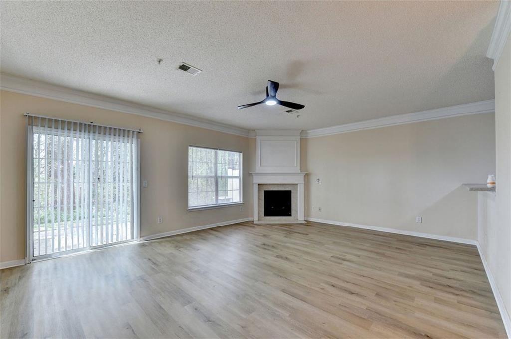 310 Azalea Circle Cumming, GA 30040 - Photo 7 of 38 a view of an empty room with wooden floor and a window