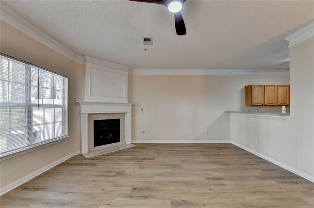 310 Azalea Circle Cumming, GA 30040 - Photo 8 of 38 a view of an empty room with a fireplace and a window