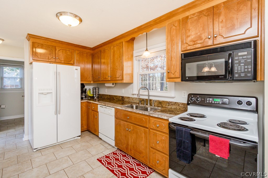 2612 Iverson Road Midlothian, VA 23112 - Photo 7 of 23 a kitchen with stainless steel appliances granite countertop a stove a sink dishwasher and a refrigerator with wooden cabinets