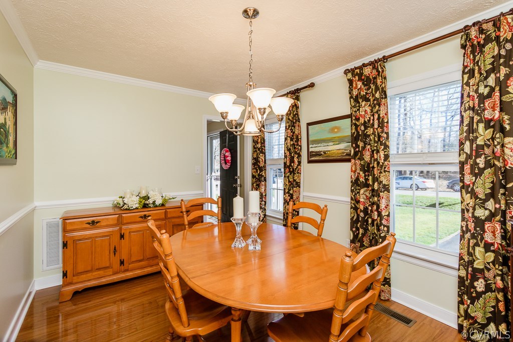 2612 Iverson Road Midlothian, VA 23112 - Photo 9 of 23 a dining room with furniture and chandelier