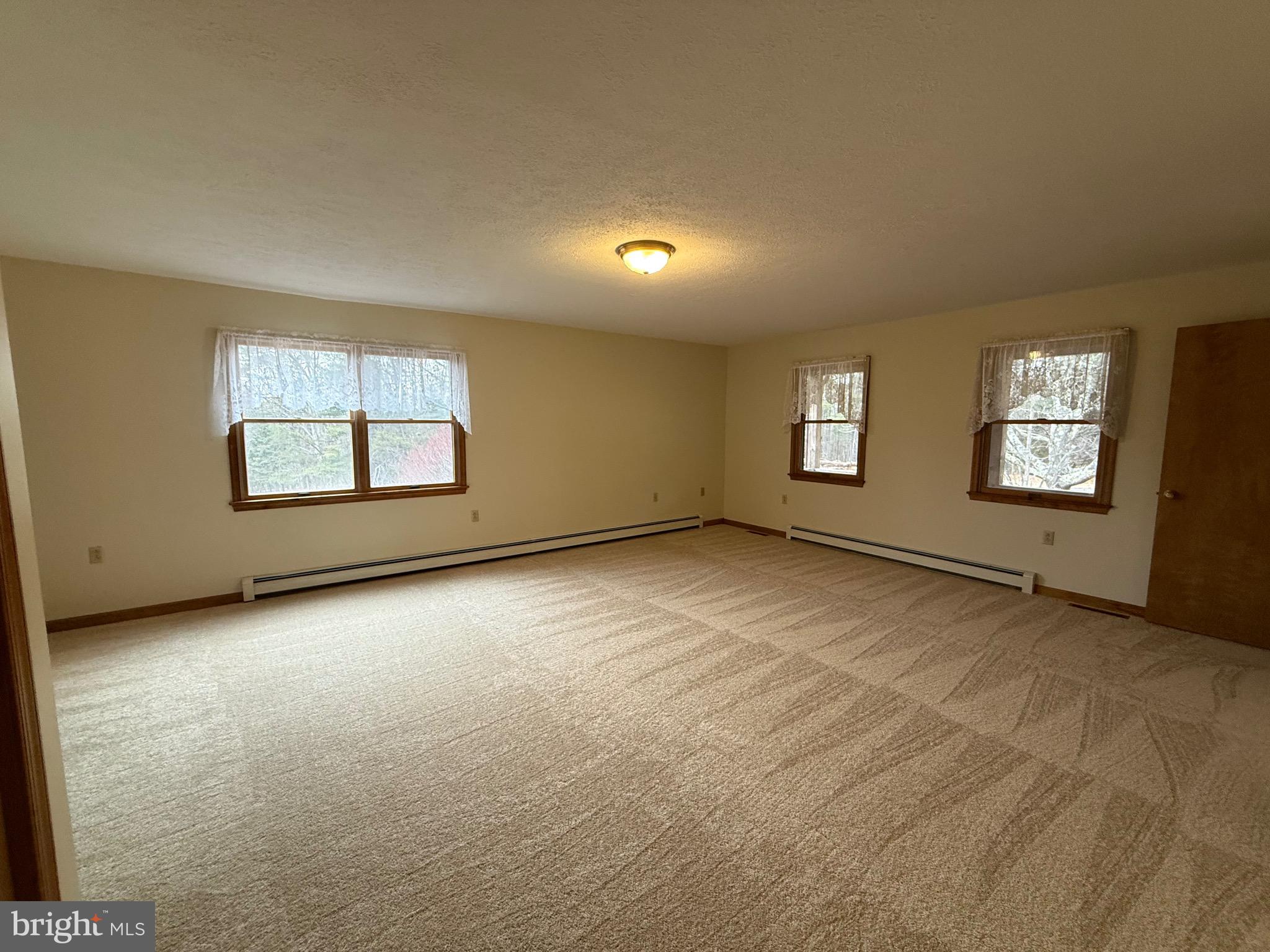 992 Silver Lane Berkeley Springs, WV 25411 - Photo 12 of 44 an empty room with windows and closet