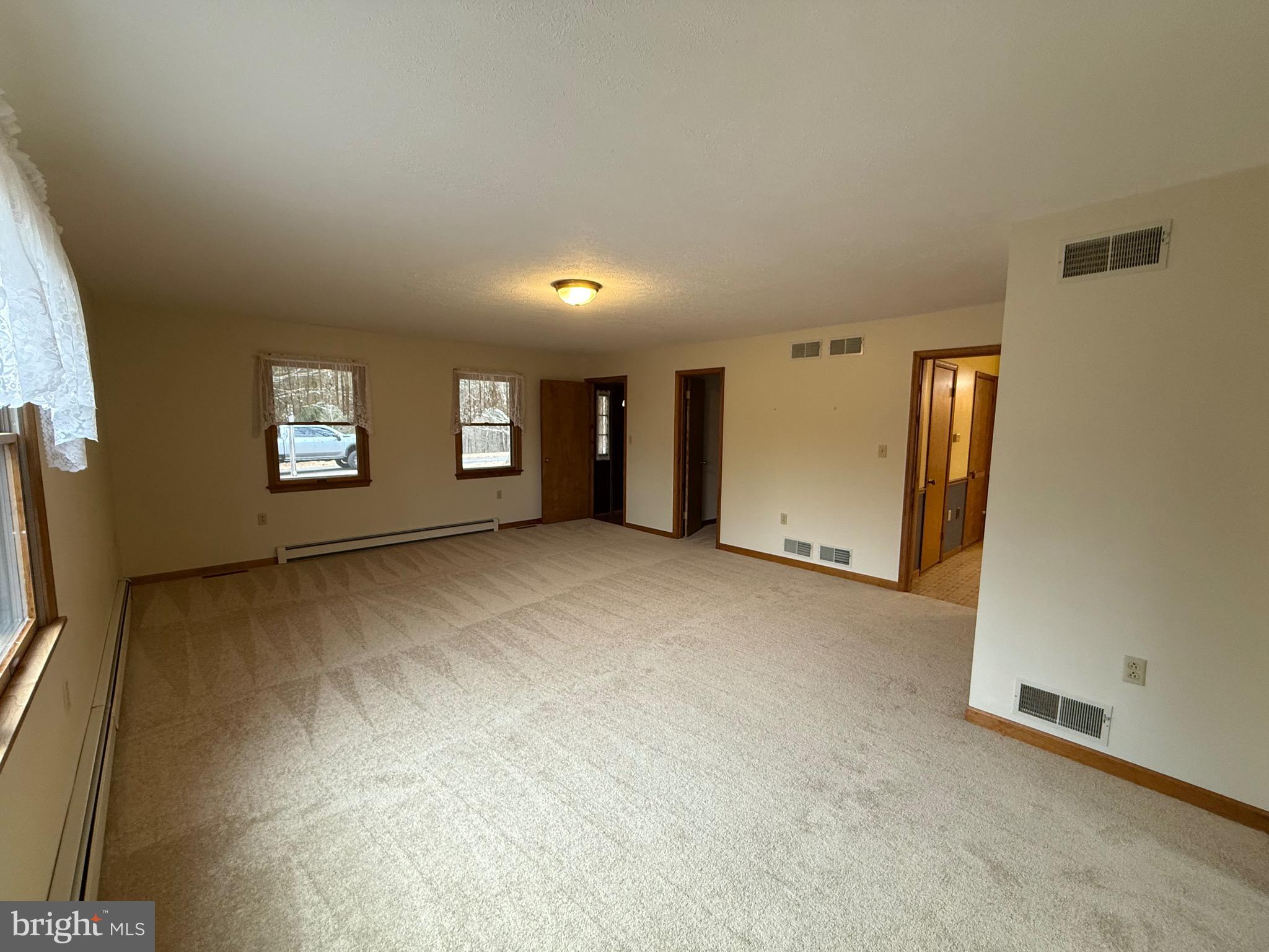 992 Silver Lane Berkeley Springs, WV 25411 - Photo 13 of 44 a view of a big room with windows and closet