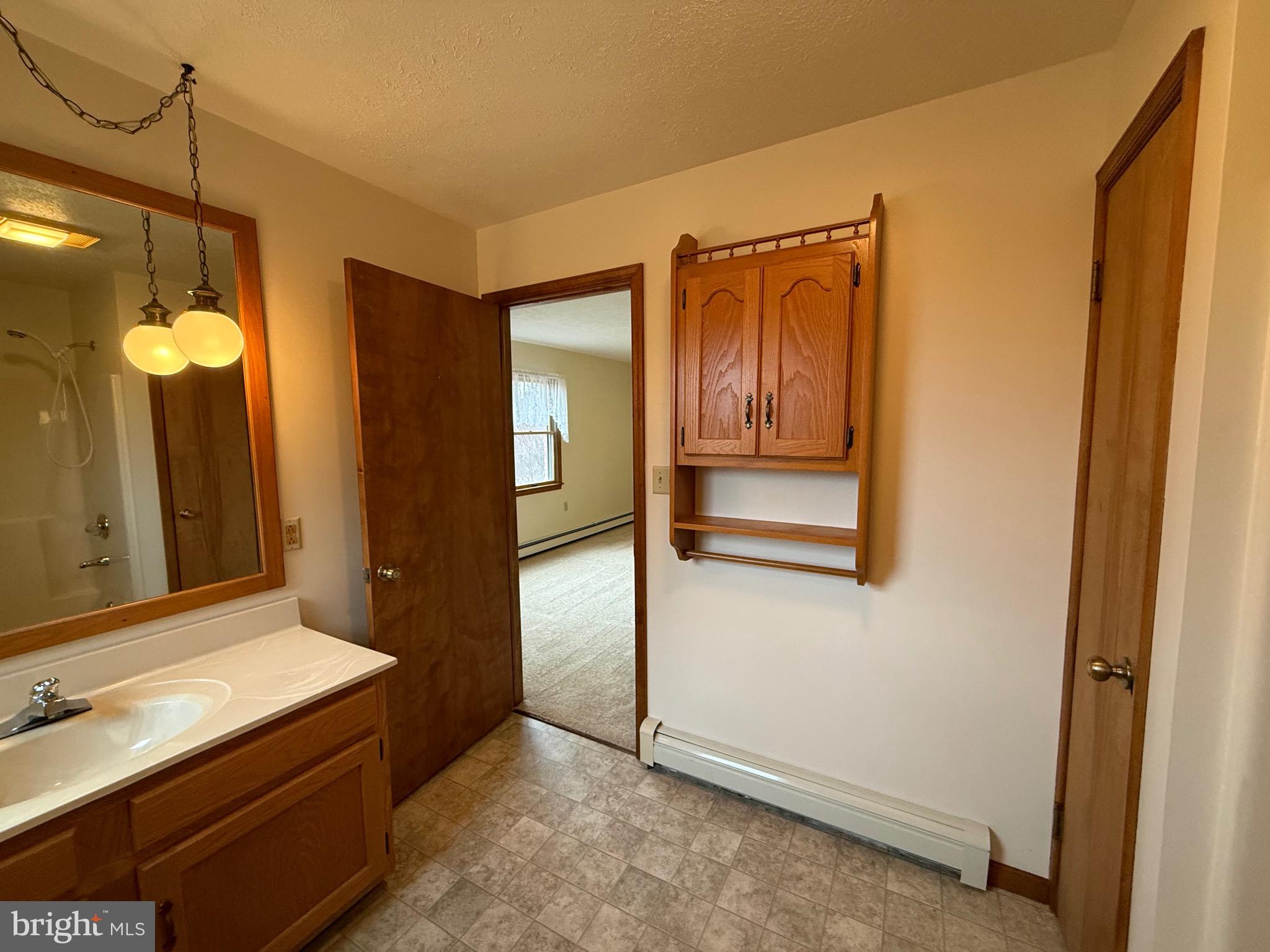 992 Silver Lane Berkeley Springs, WV 25411 - Photo 14 of 44 a bathroom with a double vanity sink and a mirror
