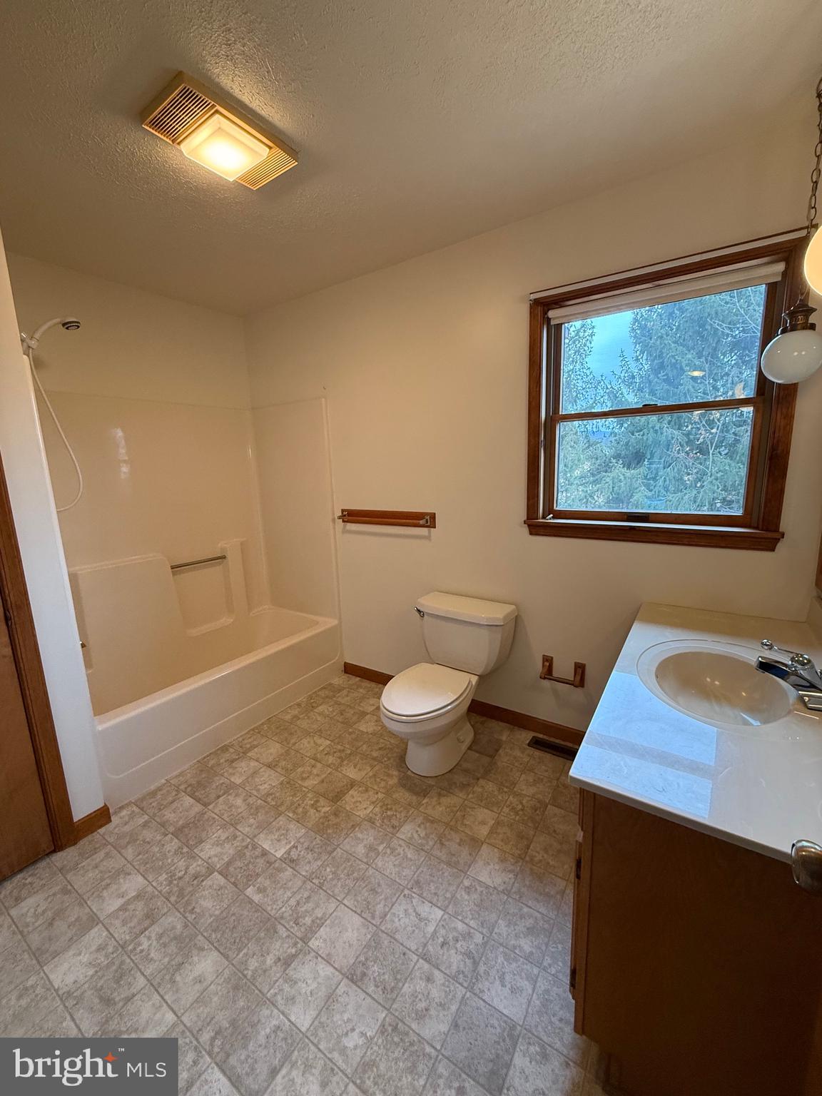 992 Silver Lane Berkeley Springs, WV 25411 - Photo 15 of 44 a bathroom with a sink mirror vanity and toilet