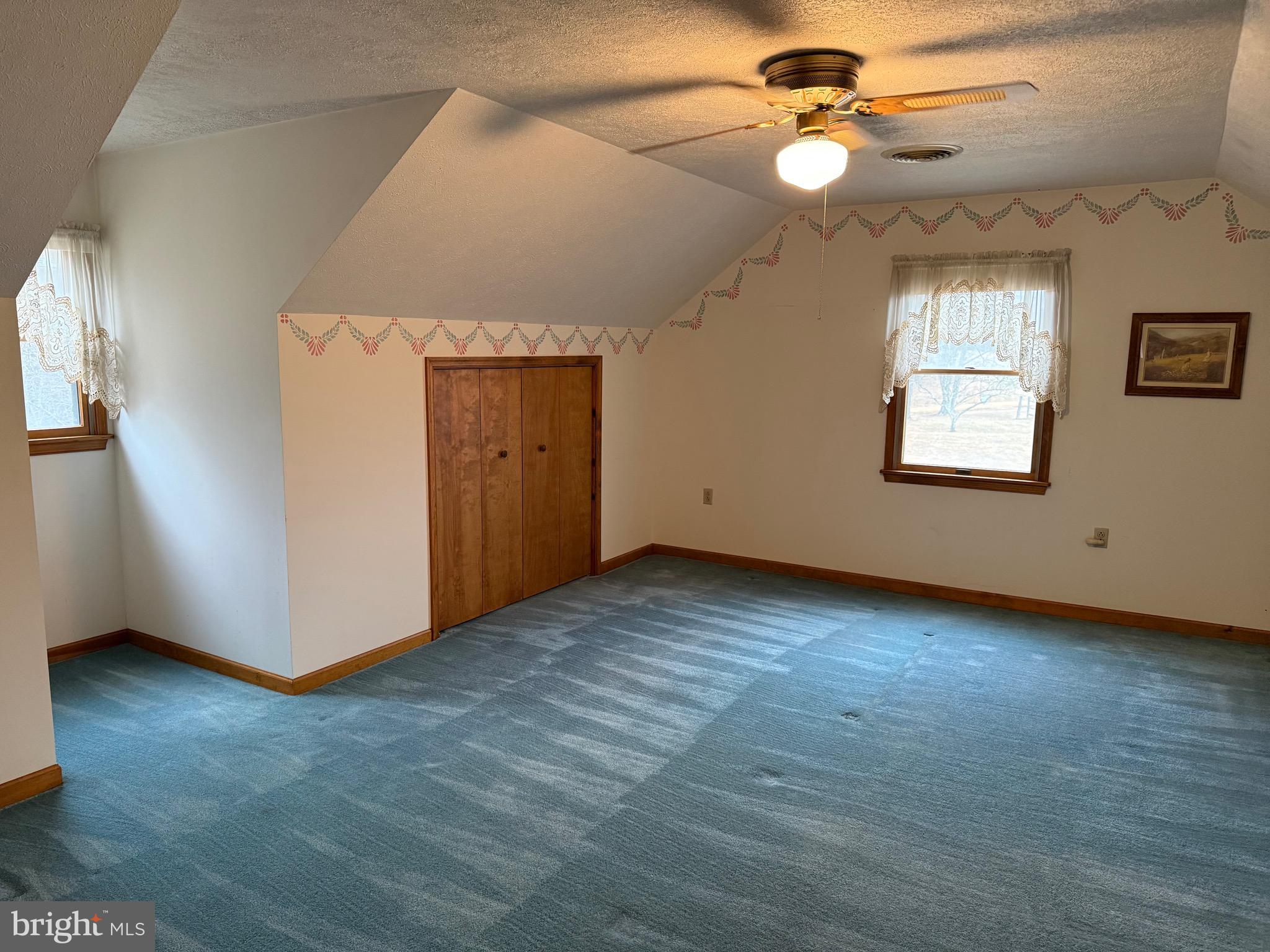 992 Silver Lane Berkeley Springs, WV 25411 - Photo 25 of 44 an empty room with windows and fan