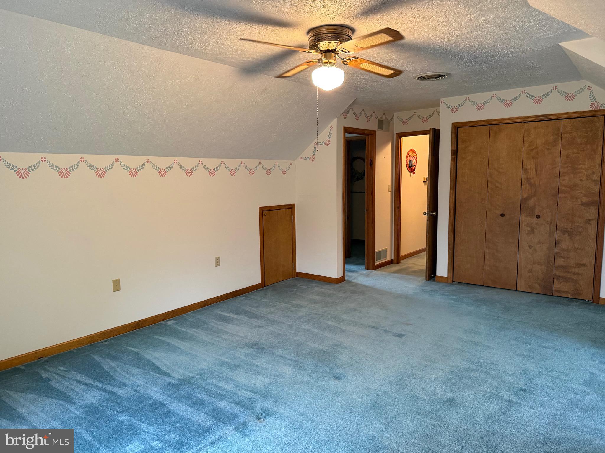 992 Silver Lane Berkeley Springs, WV 25411 - Photo 26 of 44 an empty room with a ceiling fan and a window